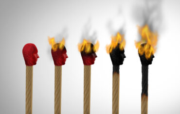 Illustration of burnout progression showing matchsticks with human heads gradually burning out, symbolizing how burnout is a workplace problem caused by chronic stress.
